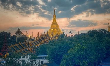 Shwedagon Pagoda at sunset in Yangon Myanmar golden stupa skyline.